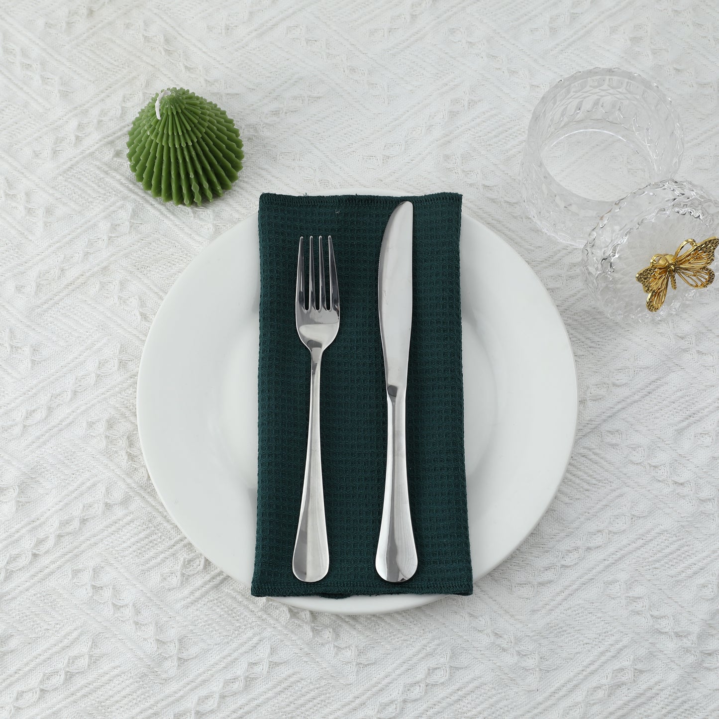 Holiday or nature themed table setting with forest green napkin