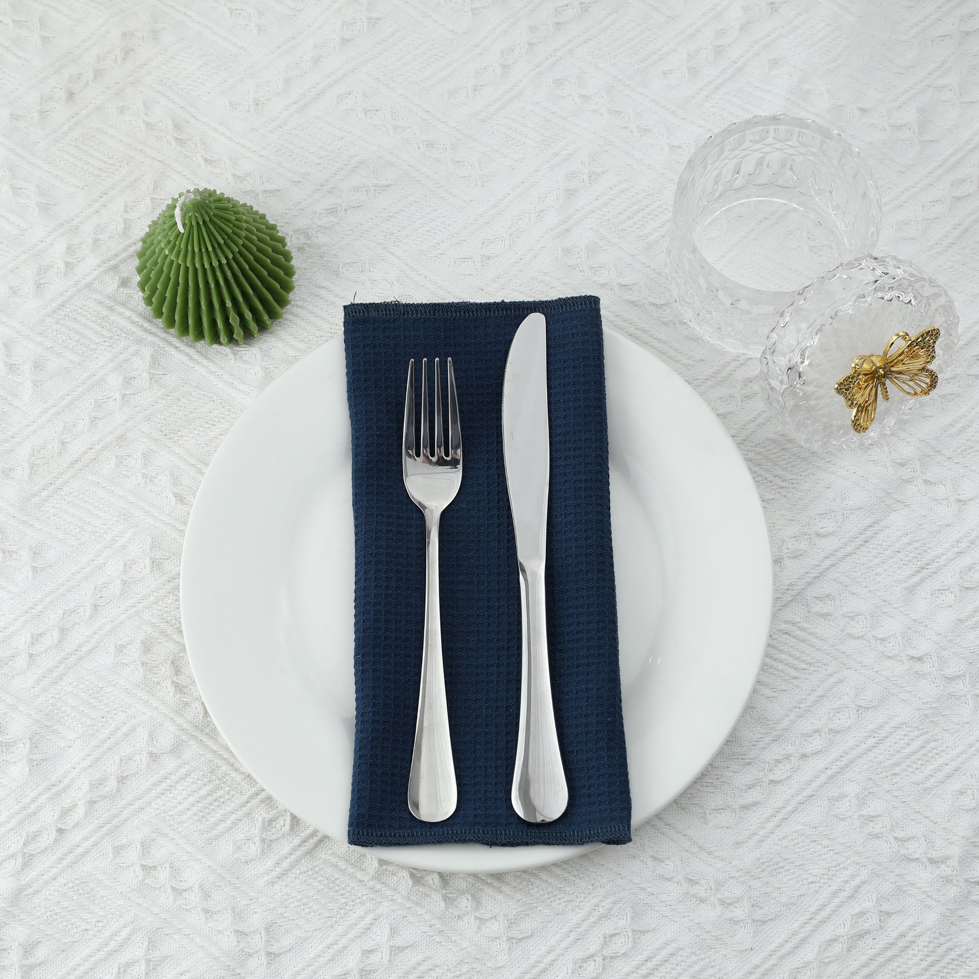 Formal dining table arrangement with navy blue waffle napkin