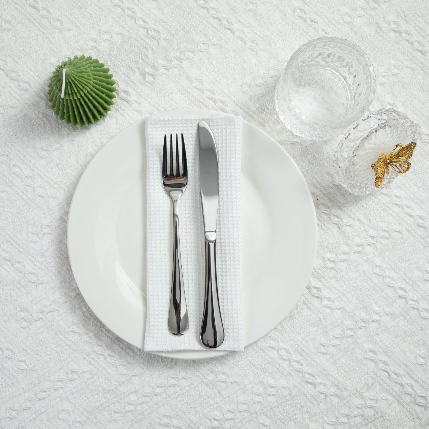 Minimalist dining table setting with white waffle napkin